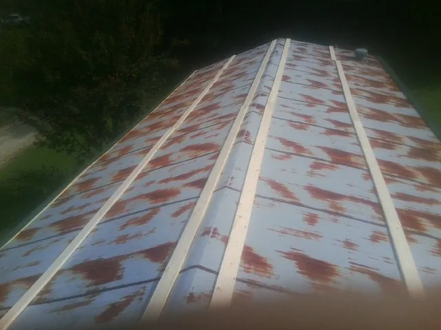 Rusted metal roof panels with new wood purlins before replacement — Storm Damage Roof Repair in Catskill by Roofing Brothers